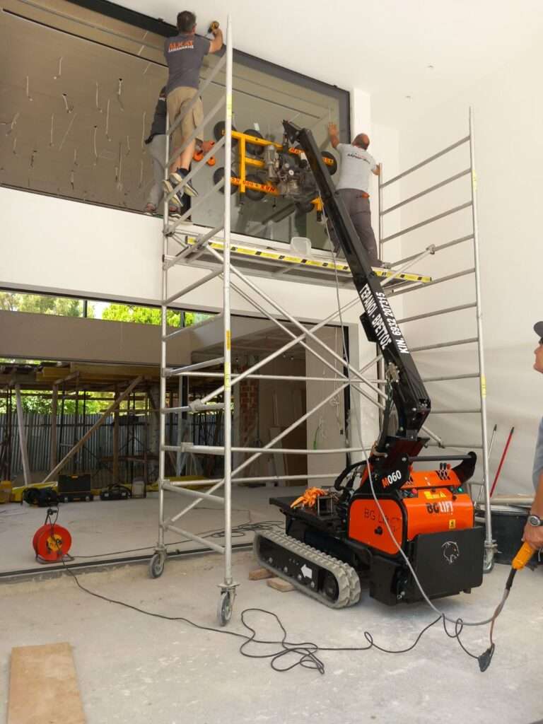 Mini ερπυστριοφόρος γερανός BG Lift M060 σε τοποθέτηση τζαμιού με βεντούζα σε εσωτερικό κτιρίου - Βρεττός Γερανοί